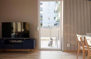 a dog standing outside a sliding glass door at Apartament Amerigo in Wrocław