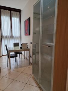 a dining room with a table and a glass closet at Locazione turistica da Lena in Piacenza +26 photos