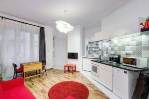 ブダペストにあるJulie's flatの赤いソファと赤い敷物付きのキッチン