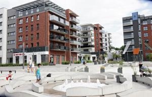 a park in the middle of a city with buildings at Apartament Amerigo in Wrocław