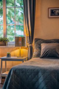 sypialnia z łóżkiem, stołem i oknem w obiekcie Willa Skalniak w mieście Lądek-Zdrój