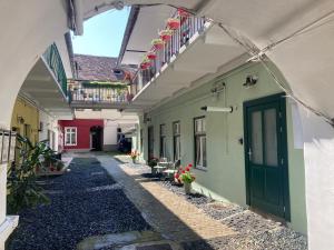 an alley with a green door and some buildings at Historical Center Residence 1 in Sibiu