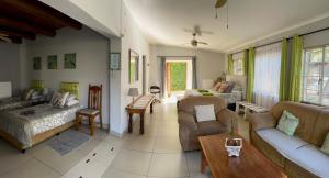 a living room with two couches and a table at Sabie Self Catering Apartments in Sabie