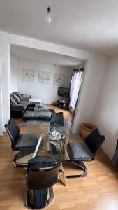 ein Wohnzimmer mit schwarzen Stühlen und einem Tisch in der Unterkunft Appartement 60 m², porte de Saint-Cloud in Boulogne-Billancourt