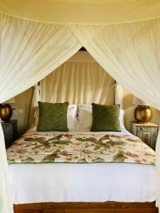 a bedroom with a bed with a canopy at Chamarel Mountain chalets in Chamarel