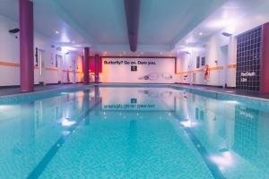 a large swimming pool in a building at Armagh City Hotel in Armagh