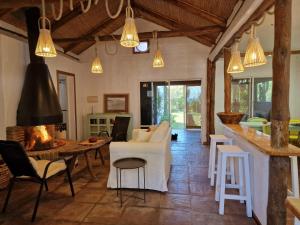 a living room with a fireplace and a table and chairs at Bolonia Beach Campus in Tarifa