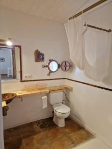 a bathroom with a toilet and a sink and a mirror at Bolonia Beach Campus in Tarifa