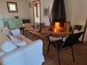 a living room with a couch and a fireplace at Bolonia Beach Campus in Tarifa