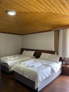 A bed or beds in a room at Gold Corner Hotel