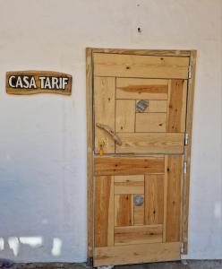 a wooden door with a sign on a wall at Bolonia Beach Campus in Tarifa