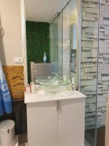 a bathroom with a glass bowl sink on a counter at Muong Thanh Luxury Condo 5min walk to Thai Consular in Vientiane