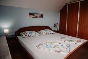a bedroom with a bed with two pillows on it at Vineyard cottage Na hribu in Dvor +37 photos