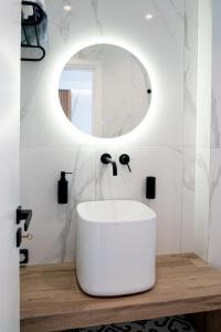 a bathroom with a white sink and a mirror at Agistri Beach in Skala