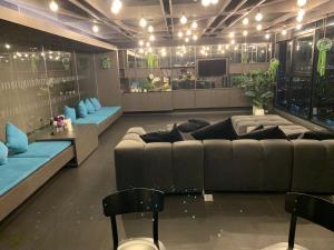 a living room with a large couch and chairs at Base Condos in Pattaya South