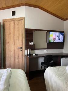 A bed or beds in a room at Gold Corner Hotel
