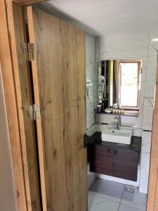 a bathroom with a sink and a wooden door at Gold Corner Hotel in Istanbul