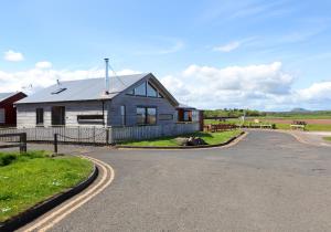 a house on the side of a road at Belle Haven Chalet. in Dunbar