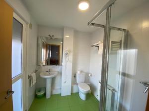a bathroom with a toilet and a sink and a shower at dpCristal Castelao in Sarria