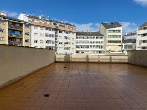 a view of a rooftop with buildings in the background at Pensión Abeledo in Sarria