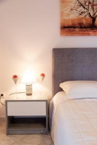 1 dormitorio con 1 cama y 1 mesa con lámpara en Natali Home, en Kanálion