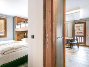a bedroom with a bed and a dining room with a table at Appartement Val-d'Isère, 3 pièces, 5 personnes - FR-1-519-22 in Val-d'Isère