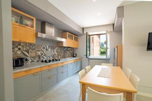 a kitchen with blue cabinets and a wooden table at Casa Comparin Appartamento Lesa in Lesa