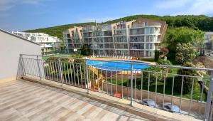 balcón con vistas a la piscina en Апартамент в Комплексе Сансет Кошарица,Солнечный берег, en Kosharitsa