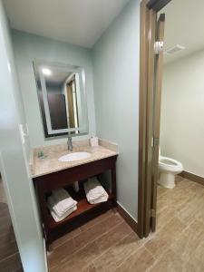 a bathroom with a sink and a toilet at Ocean Reef Suites in Kill Devil Hills