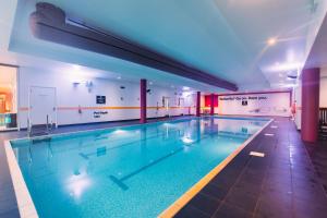 a large swimming pool in a building at Armagh City Hotel in Armagh