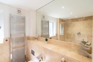 a bathroom with a shower and a large mirror at Trewhiddle Retreat V25 by Together Travel - Luxury 4-Bedroom Villa in St Austell +46 photos