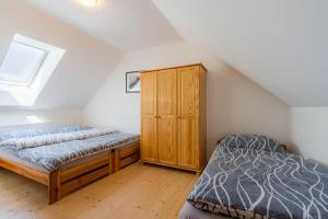 um quarto com 2 camas e um armário de madeira em Apartments Nad Rybníky em Horní Planá