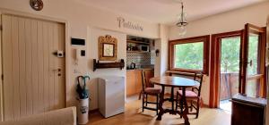 a kitchen and dining room with a table and chairs at La Maison de la montagne- Bluchalet in Courmayeur