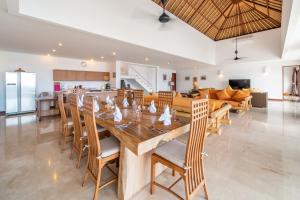 a dining room and living room with a table and chairs at Villa Dahlia, 4 bed Oceanfront Retreat, Candidasa in Manggis