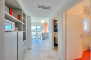 a kitchen and a living room with a table at Attico Al Parco - Happy Rentals in Lugano