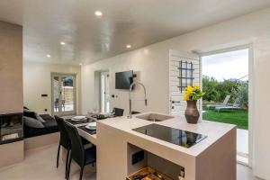 a kitchen with a counter with a table and chairs at Villa Casa Libera in Livade