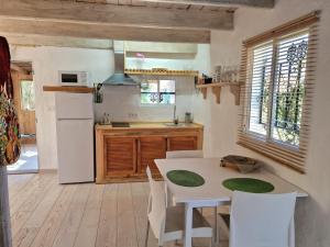 a kitchen with a white table and a white refrigerator at Bolonia Beach Campus in Tarifa