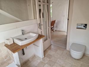 a bathroom with a sink and a toilet at Bolonia Beach Campus in Tarifa
