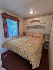 una camera con un letto in una piccola stanza di Glebe Farm Holidays a Newport