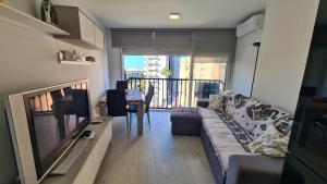 a living room with a couch and a television and a table at Apartamento Acacias IV -5 in Benidorm