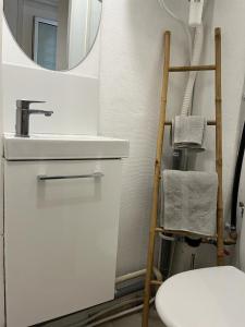 a bathroom with a white sink and a mirror at Lilliputiens in Rouen