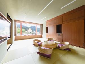 a living room with a table and chairs at Arima Kirari in Kobe