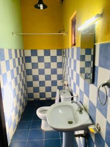 a bathroom with a sink and a toilet at Hareesha Holiday Resort in Galle
