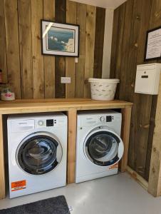 a laundry room with a washer and dryer at Glebe Farm Holidays in Newport