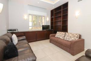 a living room with a couch and a television at Spacious & Modern 5 bed in the Center of Rechavia! in Jerusalem