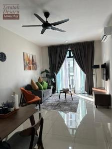 a living room with a couch and a ceiling fan at Teratak Desaru Homestay Wi-fi, Smart TV & Water Dispenser in Bandar Penawar
