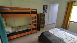 a bedroom with two bunk beds in a room at Casa JPi in São Pedro