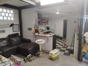 uma sala de estar com um sofá de couro e uma cozinha em Sanfermines Loft Industrial em Berrioplano