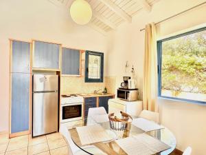 a kitchen with a table and a refrigerator at Villa Barbati Pelagos with private pool by DadoVillas in Barbati