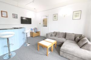 a living room with a couch and a table at Sunnydene in Great Yarmouth